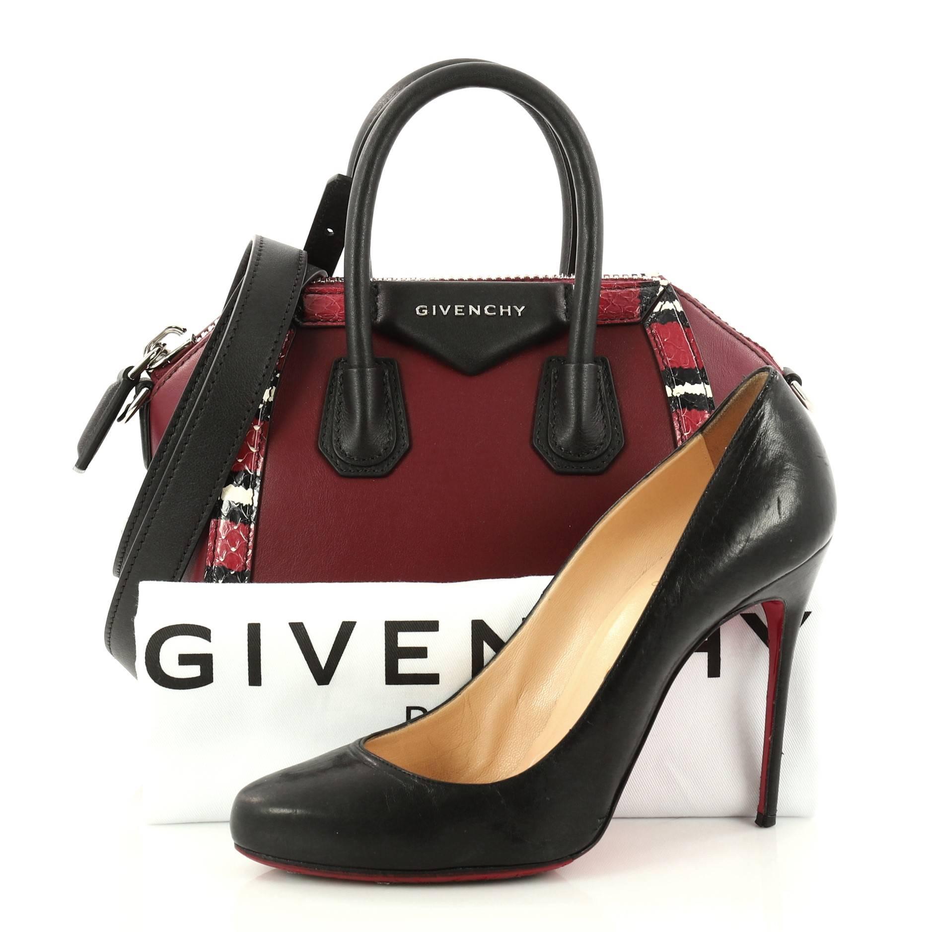 This authentic Givenchy Antigona Bag Leather with Snakeskin Mini from 2017 presents the brand's most iconic bag in a miniature version. Crafted from burgundy leather and genuine multicolor python trim, this structured handle bag features dual-rolled