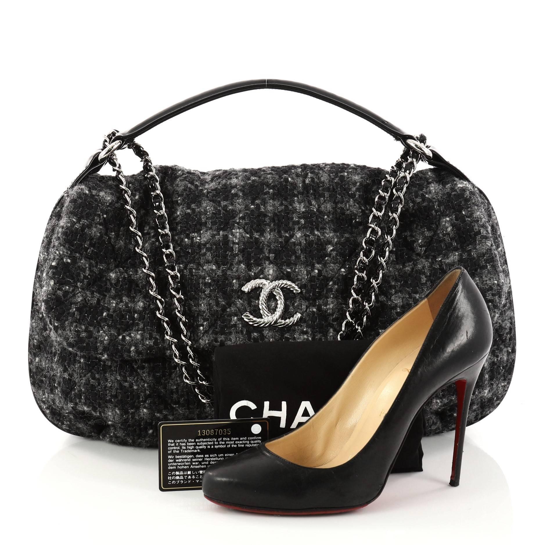 This authentic Chanel CC Flap Satchel Quilted Tweed Medium mixes youthful elegance with a timeless flair. Crafted in quilted black tweed with patent leather trims, this luxurious satchel features a single loop patent leather handle, woven-in leather