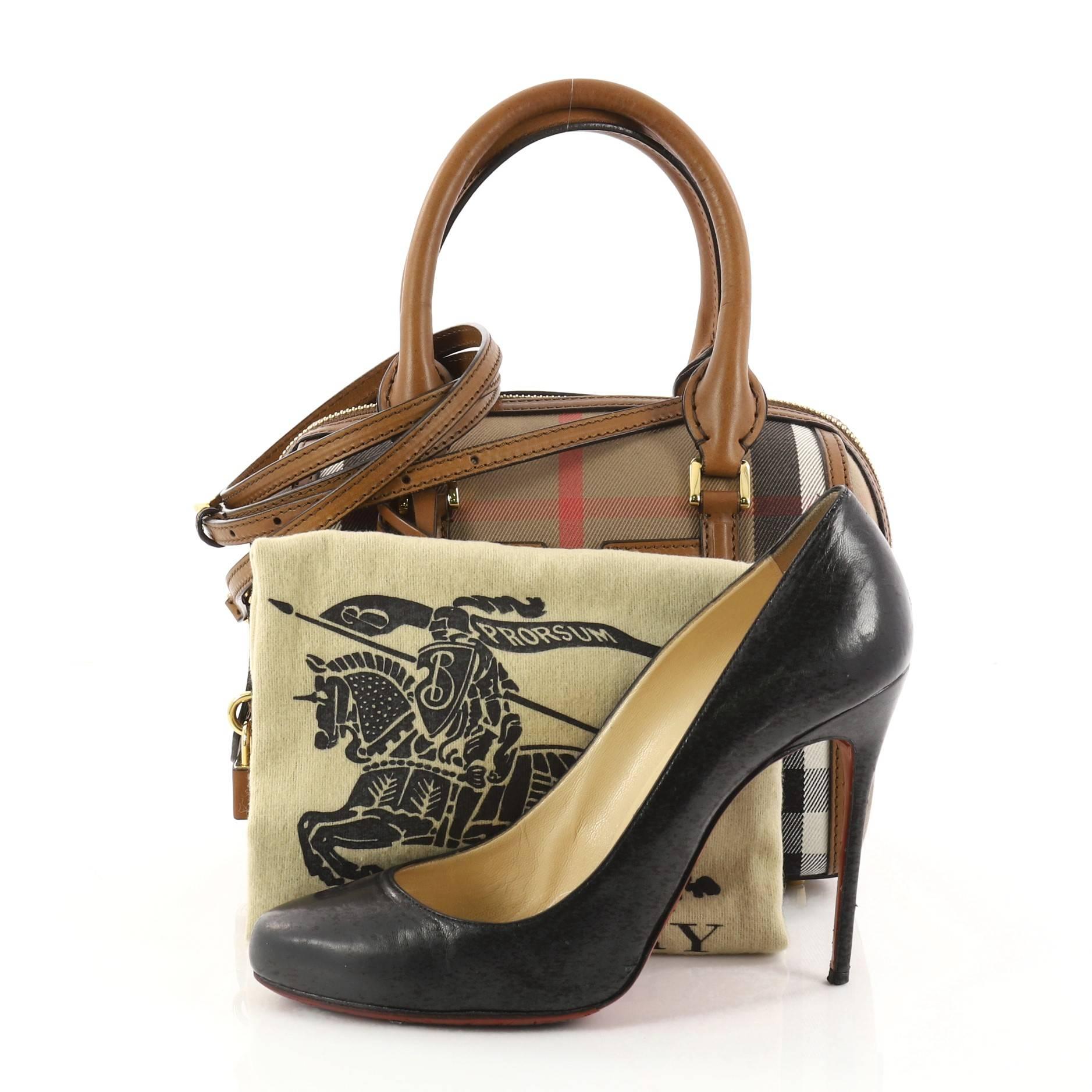 This authentic Burberry Alchester Convertible Satchel House Check and Leather Small is sophisticated yet classic in design perfect for everyday use. Crafted from Burberry's house check, this petite satchel features brown leather trims and handles,