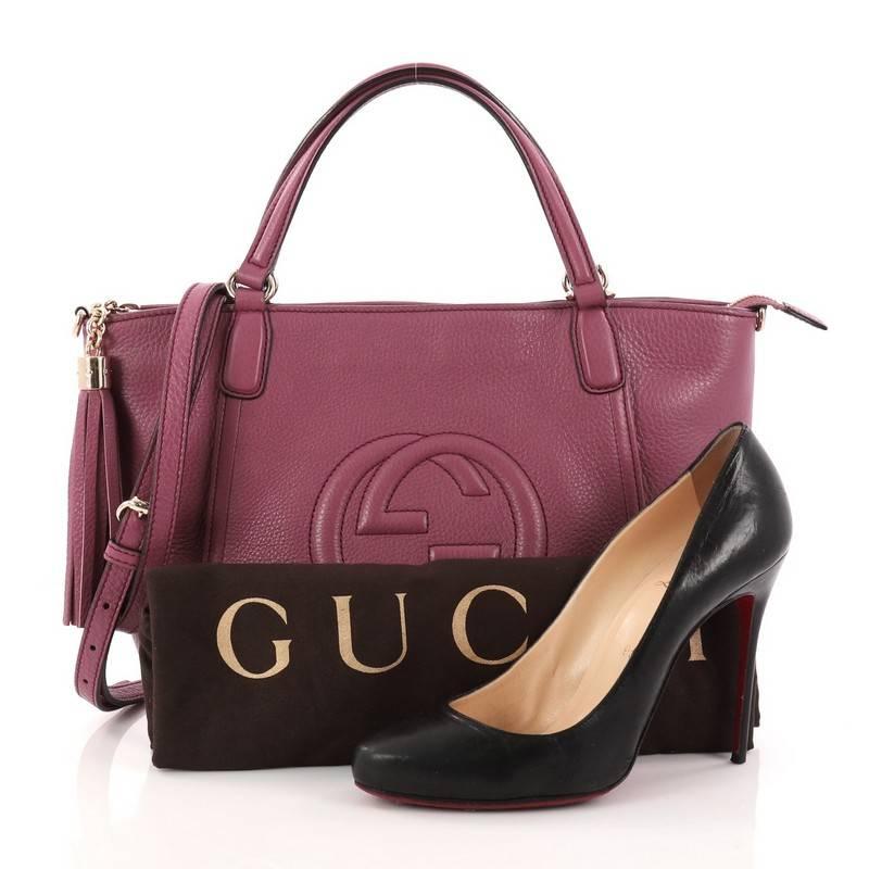 This authentic Gucci Soho Convertible Top Handle Bag Leather Medium is a fresh, chic tote made for everyday excursions. Crafted from purple leather, this no-fuss tote features Gucci's signature interlocking GG logo stitched at the front, dual looped