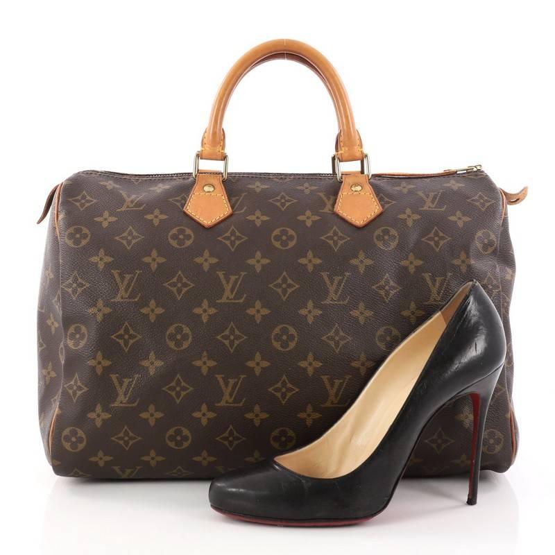 This authentic Louis Vuitton Speedy Handbag Monogram Canvas 35 is a classic must-have, making it ideal for everyday use. Constructed from Louis Vuitton's classic brown monogram coated canvas, this iconic Speedy features dual-rolled vachetta leather