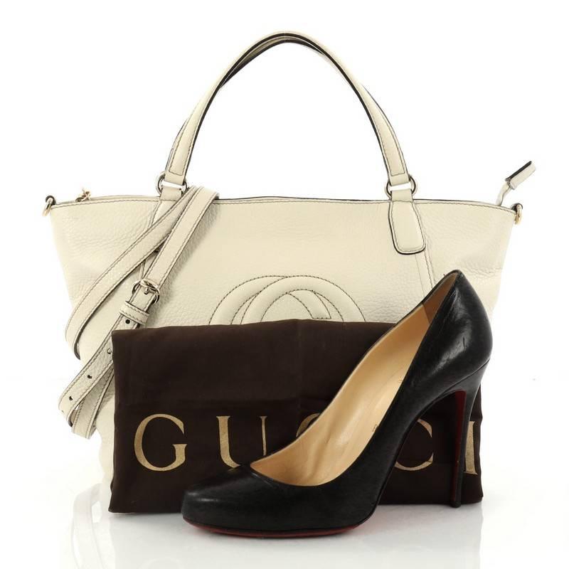 This authentic Gucci Soho Convertible Top Handle Bag Leather Small is a fresh casual-chic tote made for everyday excursions. Crafted from off-white leather, this no-fuss tote features Gucci's signature interlocking GG logo stitched at the front,