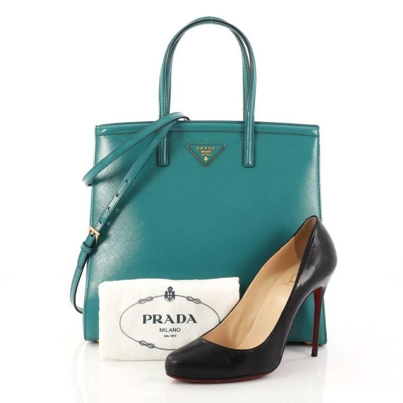This authentic Prada Slim Convertible Tote Vernice Saffiano Leather Medium is elegant in its simplicity and structure. Crafted from turquoise vernice saffiano leather, this sturdy and spacious tote features dual-rolled handles, gusseted side with