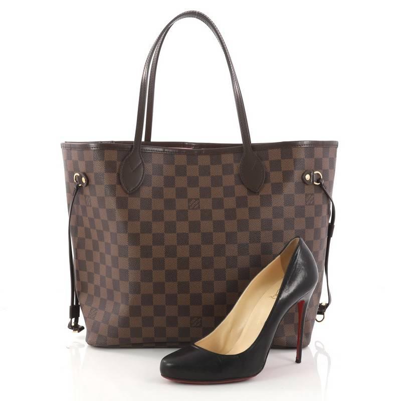 This authentic Louis Vuitton Neverfull NM Tote Damier MM is a popular and practical oversized tote beloved by many. Constructed with Louis Vuitton's signature damier ebene coated canvas, this tote features dual slim dark brown leather handles, side