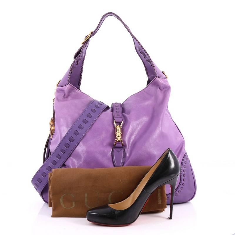 This authentic Gucci New Jackie Handbag Leather Large is a must-have luxurious everyday hobo fit for the modern woman. Constructed from purple leather, this bag features adjustable buckle shoulder strap with whipstitch detailing, side fringe tassels