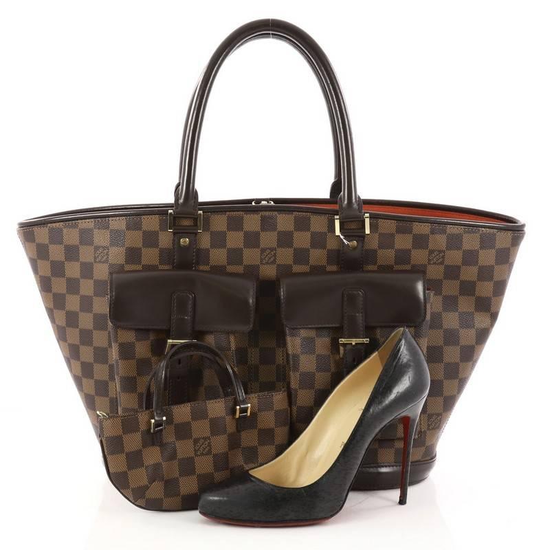 This authentic Louis Vuitton Manosque Handbag Damier GM mixes fashion and functionality all rolled into one. Crafted from damier ebene coated canvas, this chic structured tote features dual-rolled leather handles, dark brown leather trims, two