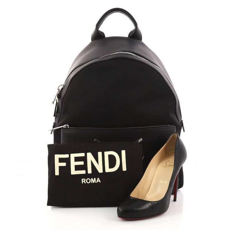 This authentic Fendi Faces Backpack Nylon and Leather is a stylish and unique backpack perfect for your daily excursions. Crafted from black nylon with calf leather, this backpack features rolled leather handles, adjustable flat padded fabric