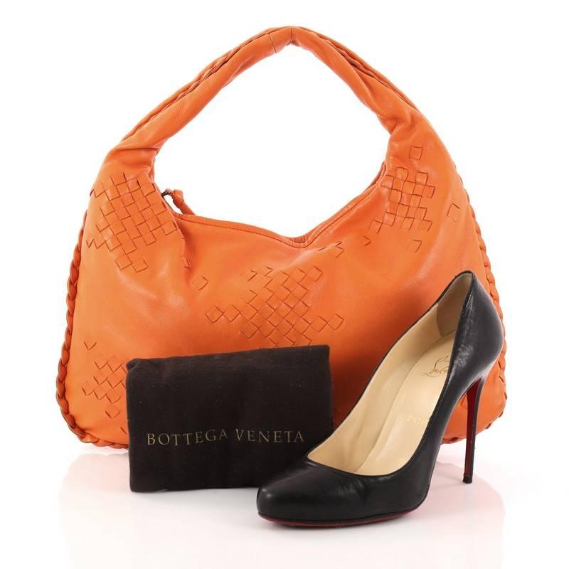 This authentic Bottega Veneta Hobo Leather with Intrecciato Detail Medium is a timelessly elegant bag with a casual silhouette. Excellently crafted from orange leather with woven Bottega Veneta's signature intrecciato detailing, this no-fuss hobo