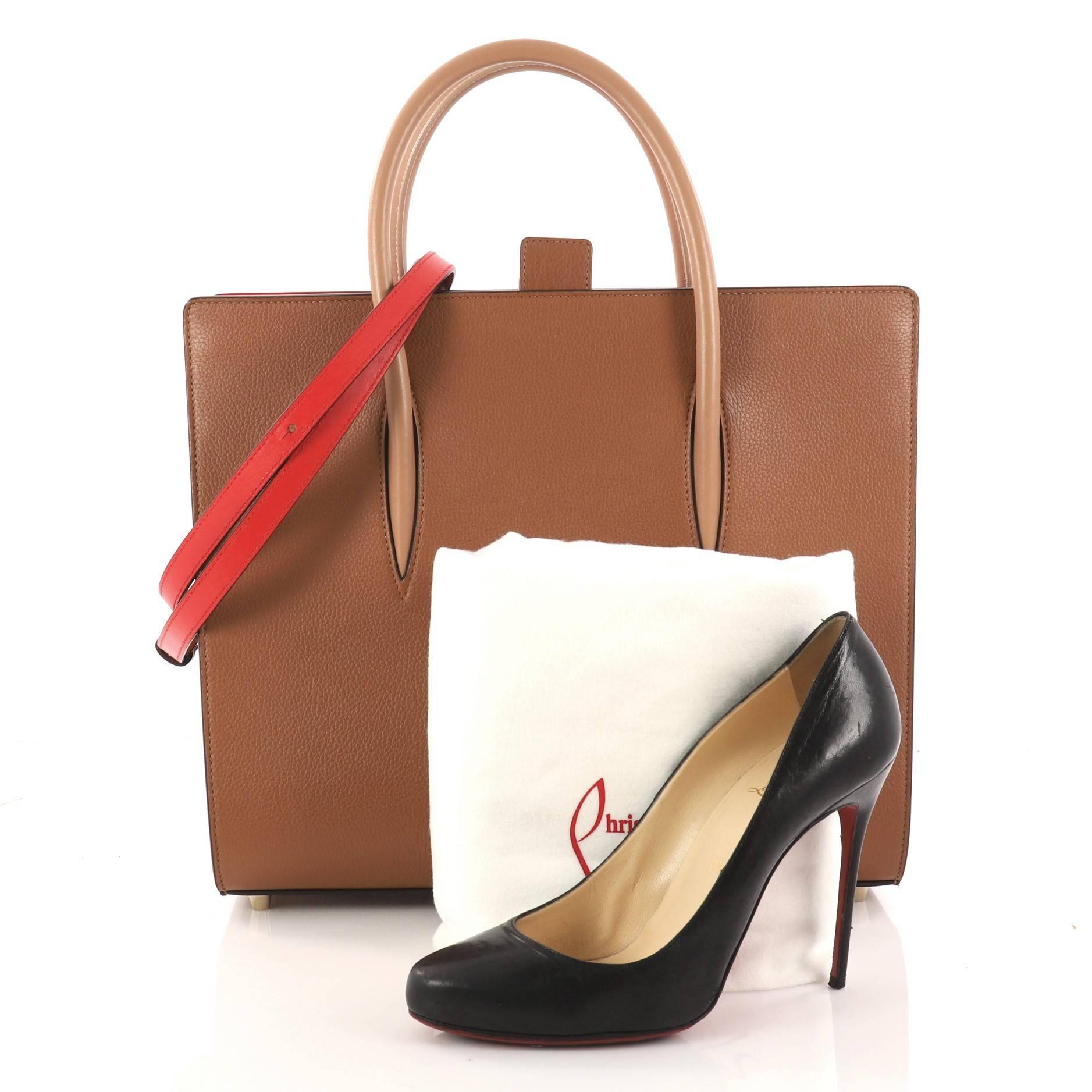 This authentic Christian Louboutin Paloma Tote Leather Large is an elegant edgy handbag made for the modern woman. Crafted in brown leather, this bag features dual-rolled leather handles, spiked patent leather on the sides, protective base studs,