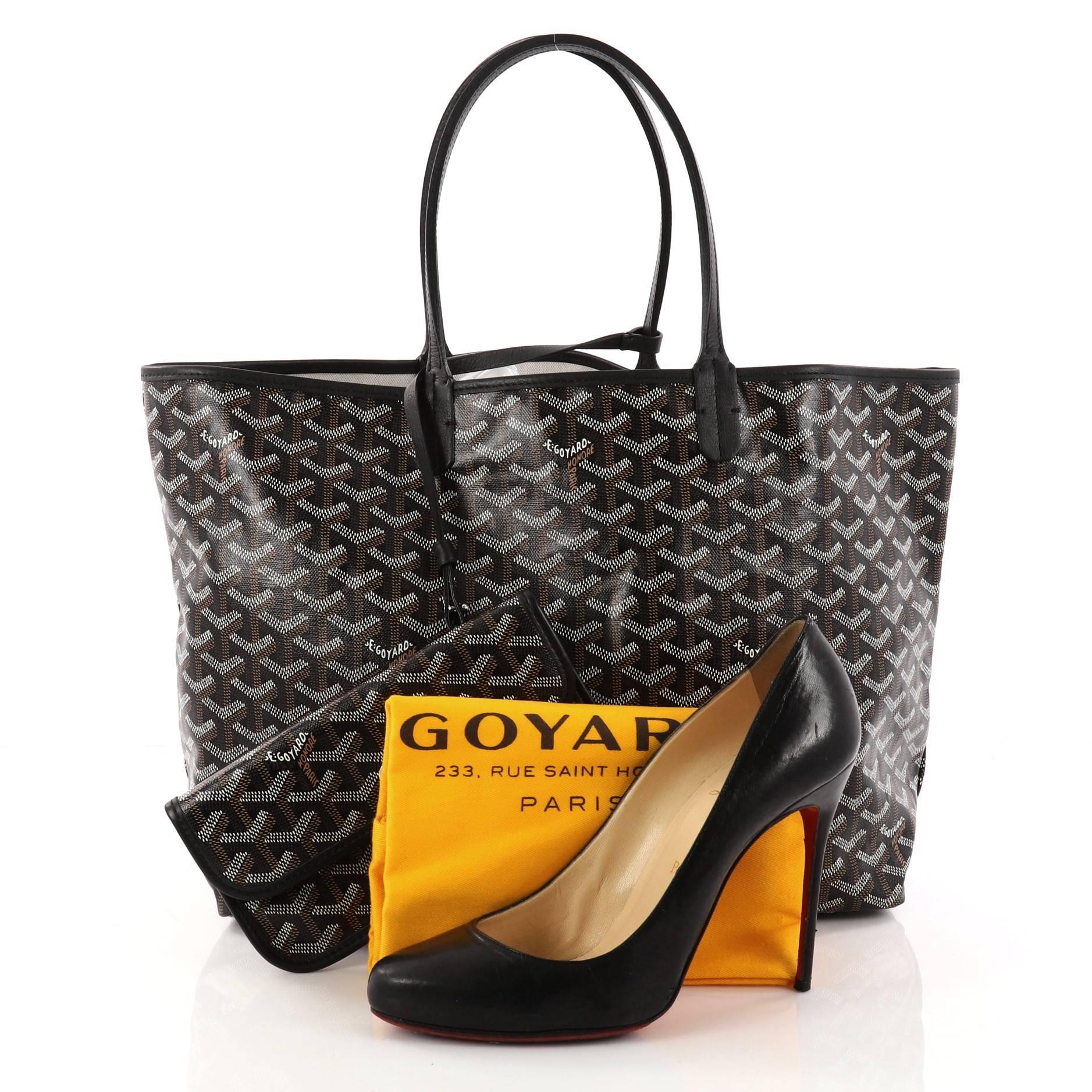 This authentic Goyard St. Louis Tote Coated Canvas PM is an ideal bag for everyday excursions. Crafted from popular and traditional black, brown, and white Goyard chevron coated canvas, this spacious tote features long thin leather handles, black