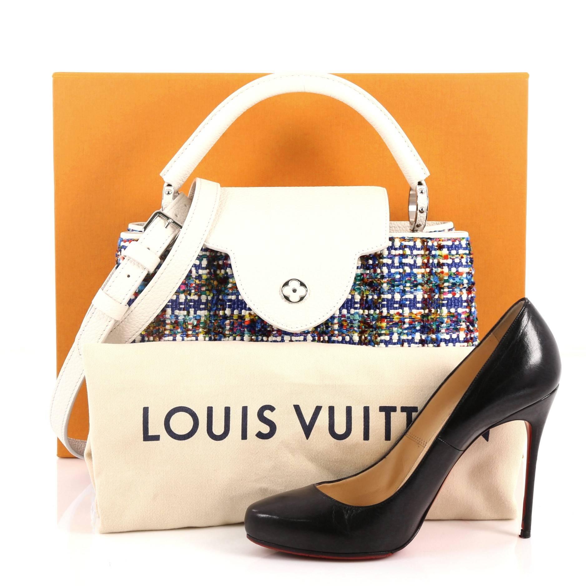 This authentic Louis Vuitton Capucines Handbag Limited Edition Broderies PM is sophisticated and ladylike luxurious bag inspired by the brands' Parisian heritage. Crafted from blue tweed broderies, this chic stand-out bag features a single loop