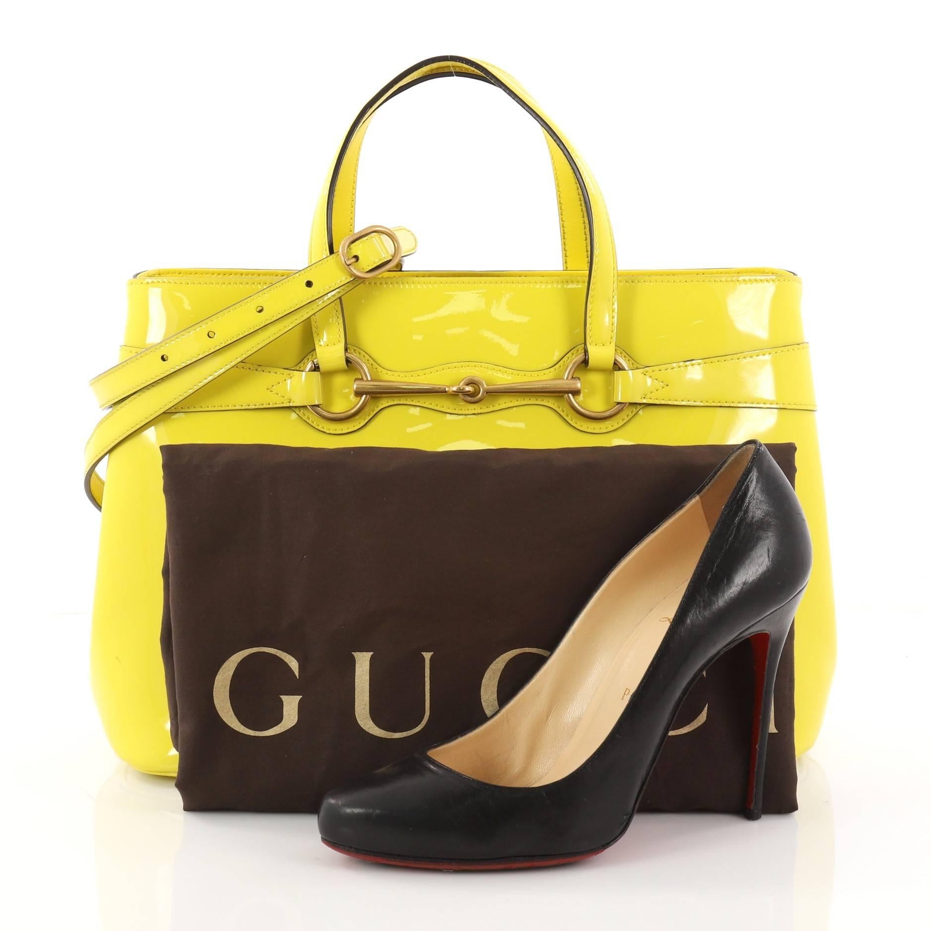 This authentic Gucci Bright Bit Convertible Tote Patent Medium is simple yet undeniably elegant, which makes it the perfect tote for the fashion savvy woman. Crafted from yellow patent leather, this gorgeous bag features dual flat leather handles,