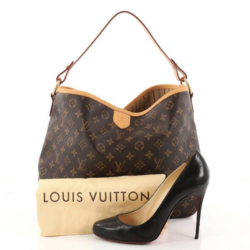 This authentic Louis Vuitton Delightful Handbag Monogram Canvas PM is a versatile tote that can be used every day. Constructed from the brand's classic brown monogram coated canvas with cowhide leather trims, this elegant, city tote features a flat