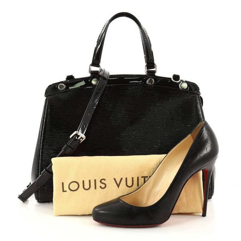 This authentic Louis Vuitton Brea Handbag Electric Epi Leather MM is a staple for an everyday look. Crafted from black electric Epi leather, this structured yet feminine tote features dual flat leather handles, engraved LV studs, subtle embossed LV