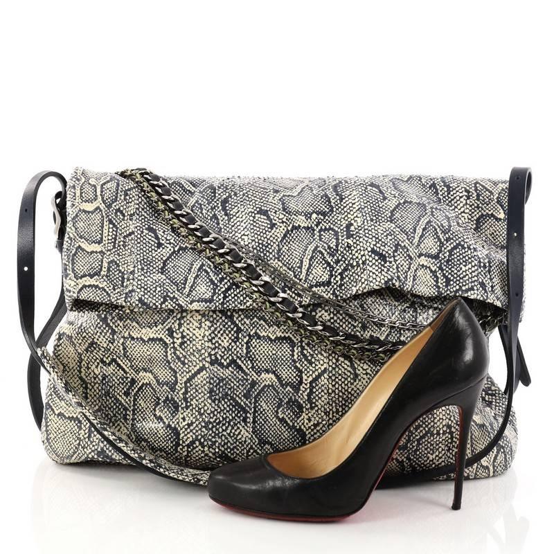 This authentic Jimmy Choo Boho Biker Hobo Python Large mixes casual-cool style with sartorial edge. Crafted in genuine beige and navy python skin, this stylish hobo features a single strap, zip top fold over silhouette with a triad of draped chains,