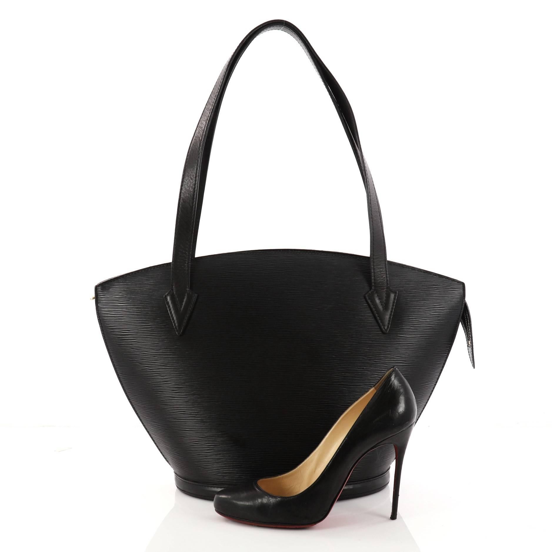 This authentic Louis Vuitton Saint Jacques Handbag Epi Leather GM is refined and elegant. Crafted from Louis Vuitton's signature sturdy black epi leather, this fan-shaped bag features dual flat leather straps, subtle LV logo at the front and a