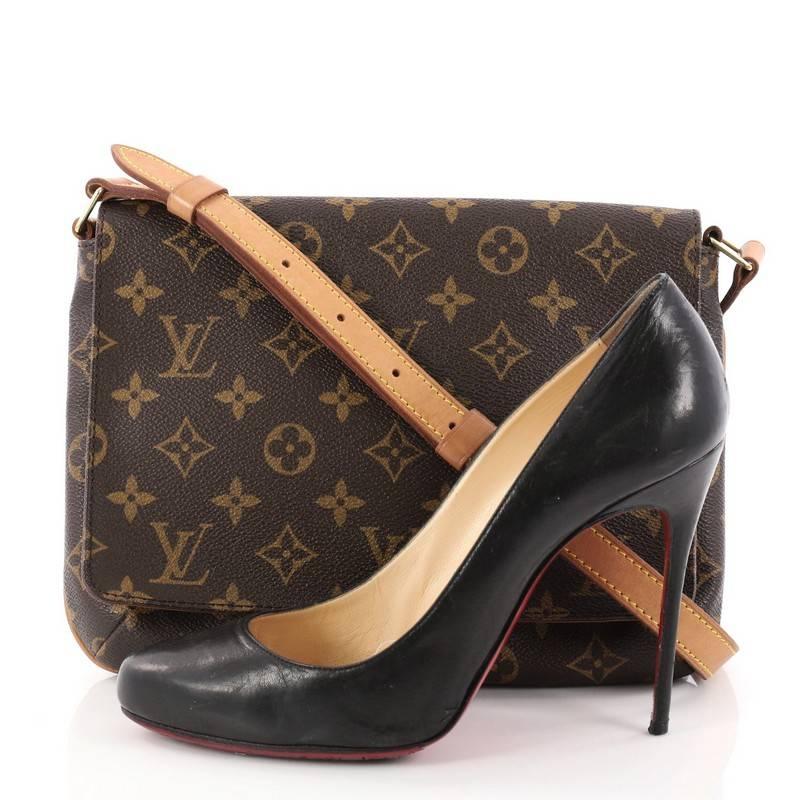 This authentic Louis Vuitton Musette Tango Handbag Monogram Canvas is the perfect bag for any casual chic outfit. Crafted with classic Louis Vuitton brown monogram coated canvas, this simple, classic design bag features a full flap style, adjustable