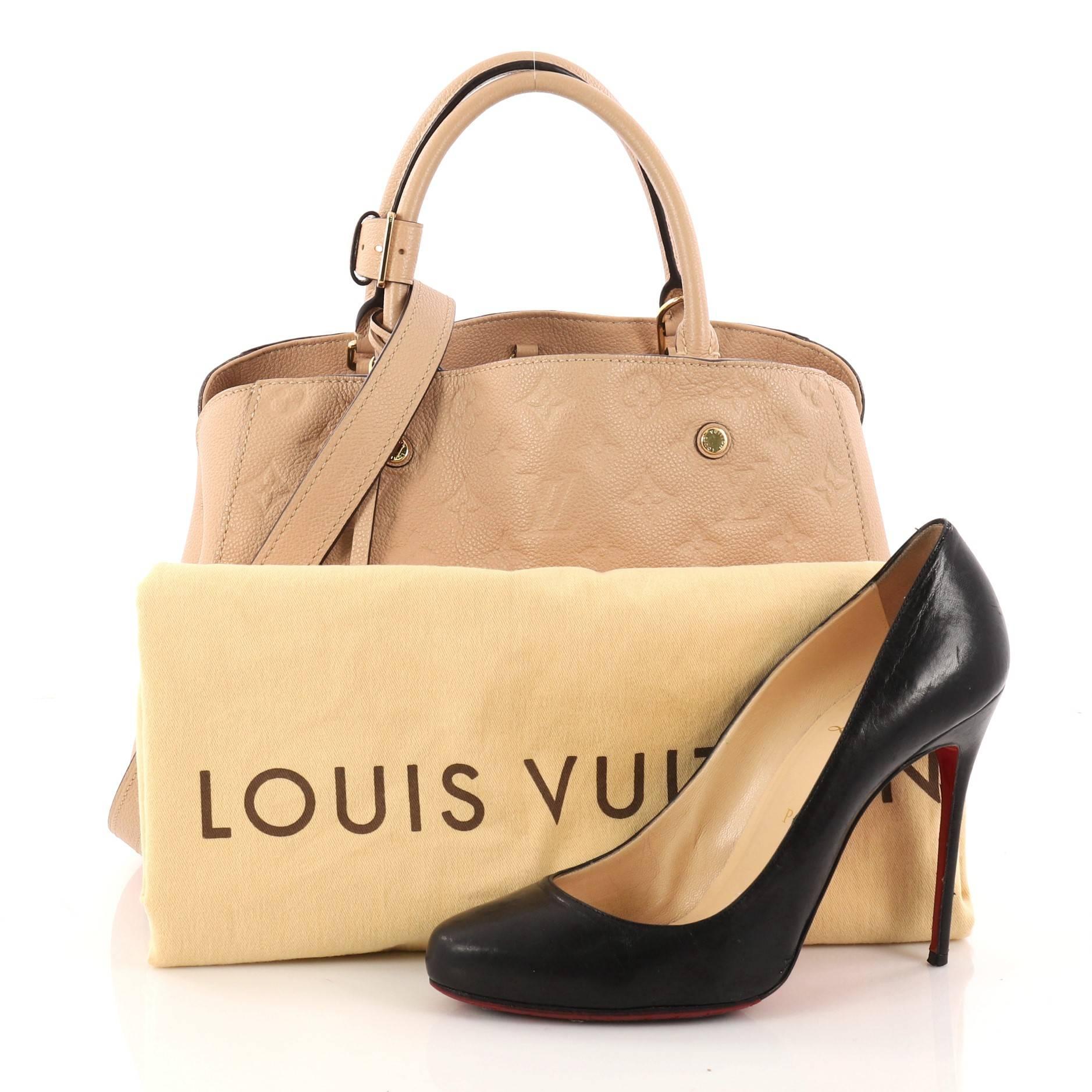 This authentic Louis Vuitton Montaigne Handbag Monogram Empreinte Leather MM named after the famed Parisian location is as sophisticated as it is sturdy. Crafted in beige embossed monogram empreinte leather, this luxurious and refined bag features