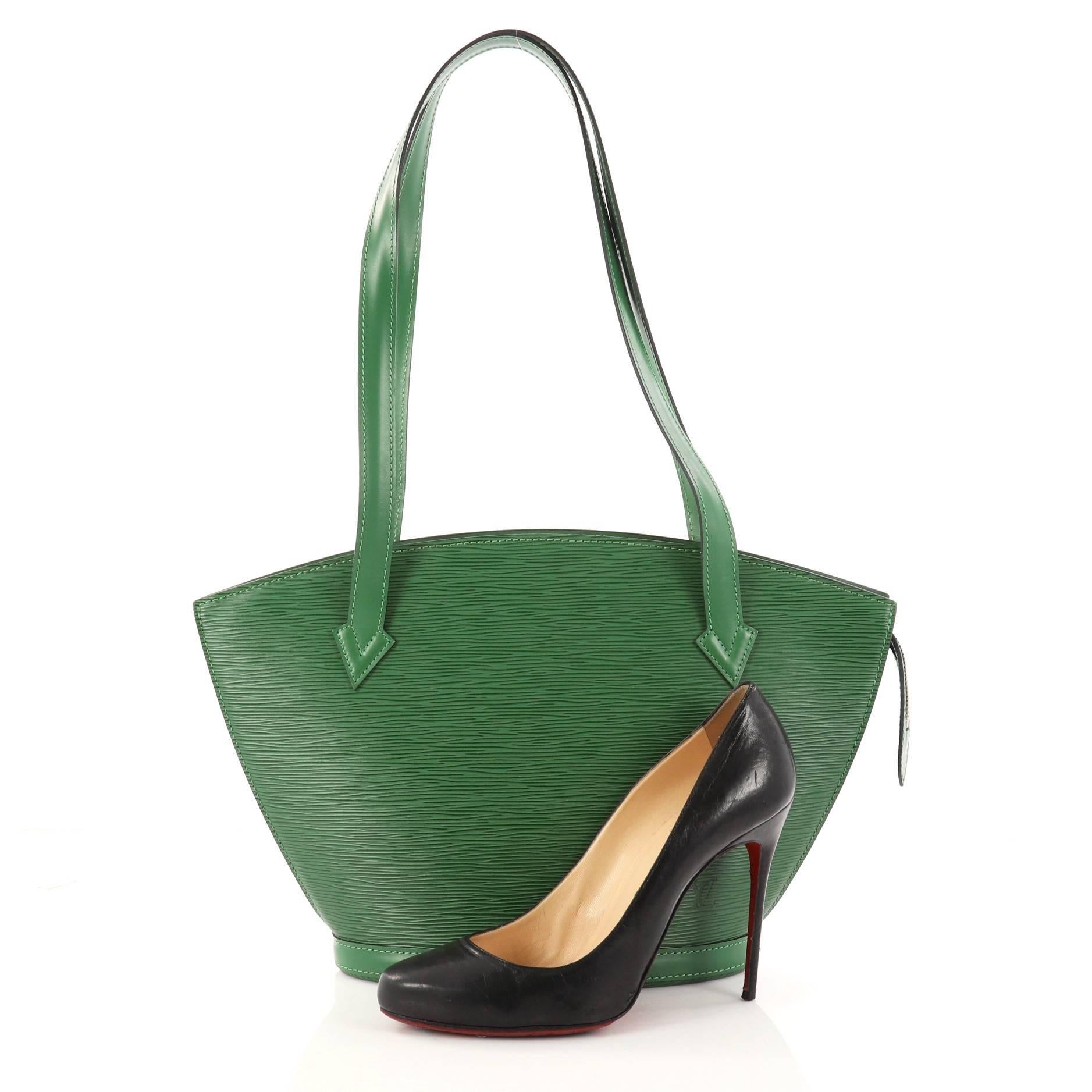 This authentic Louis Vuitton Saint Jacques Handbag Epi Leather PM is refined and elegant. Crafted from Louis Vuitton's signature green epi leather, this fan-shaped bag features long straps, subtle LV logo at the front and gold-tone zip closure. Its