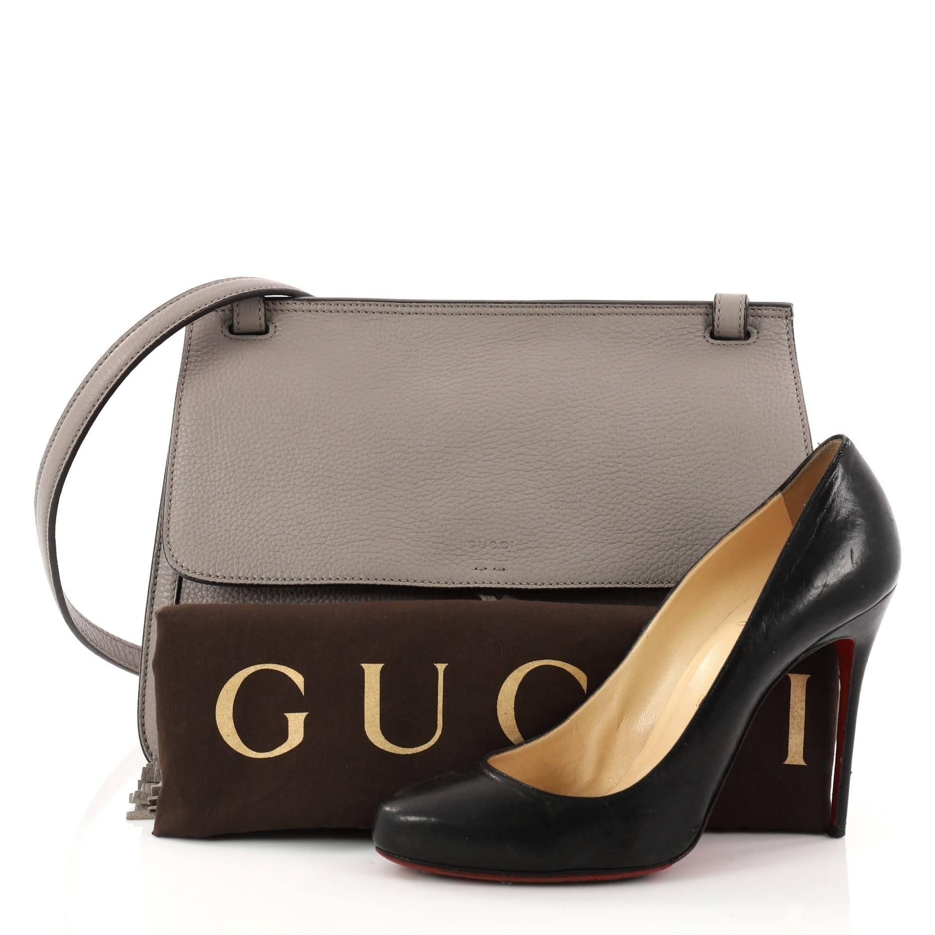This authentic Gucci Bamboo Daily Flap Bag Leather is a simple yet elegant daily crossbody bag for on-the-go woman. Crafted in grey leather, this easy-chic bag features frontal flap with bamboo tassel fringes, adjustable leather strap, subtle Gucci