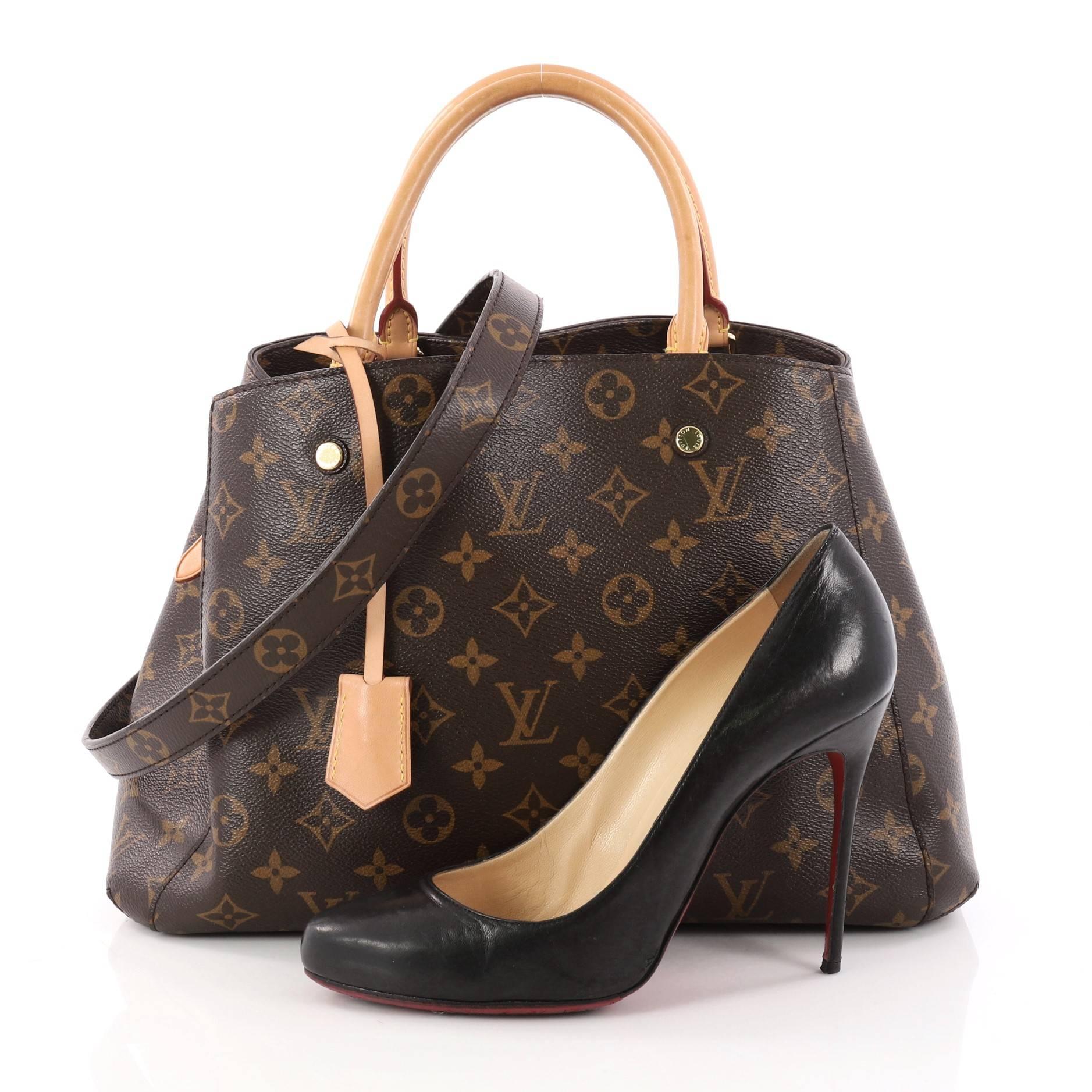 This authentic Louis Vuitton Montaigne Handbag Monogram Canvas MM named after the famed Parisian location is a sophisticated bag. Crafted from the iconic Louis Vuitton's brown monogram coated canvas, this tote features dual-rolled vachetta leather