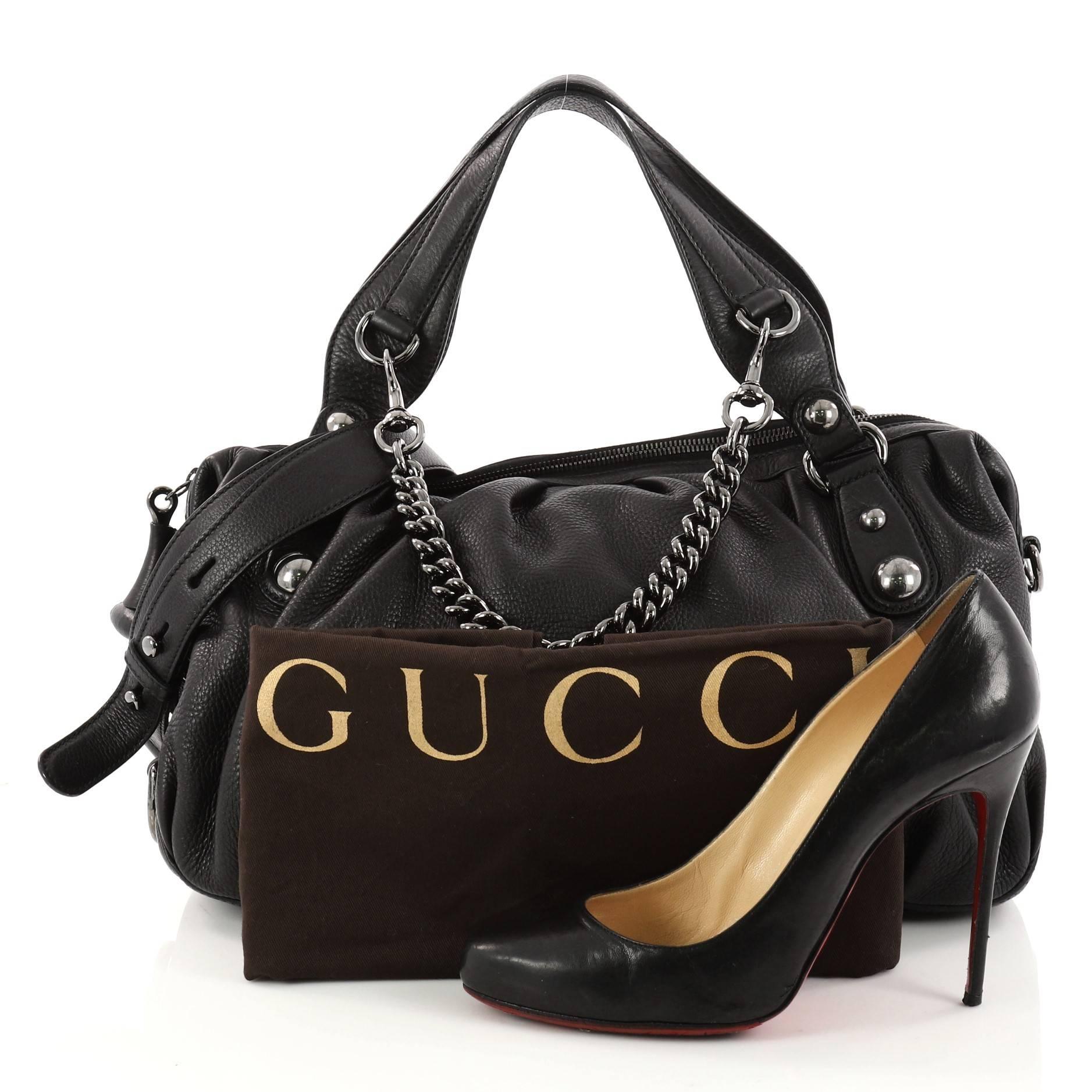 This authentic Gucci Icon Bit Satchel Leather Medium mixes the brand's classic and chic designs with an edgy twist. Crafted in sleek black leather, this rock-chic satchel features a pleated silhouette, dual-top handles, metal horsebit pull tag,