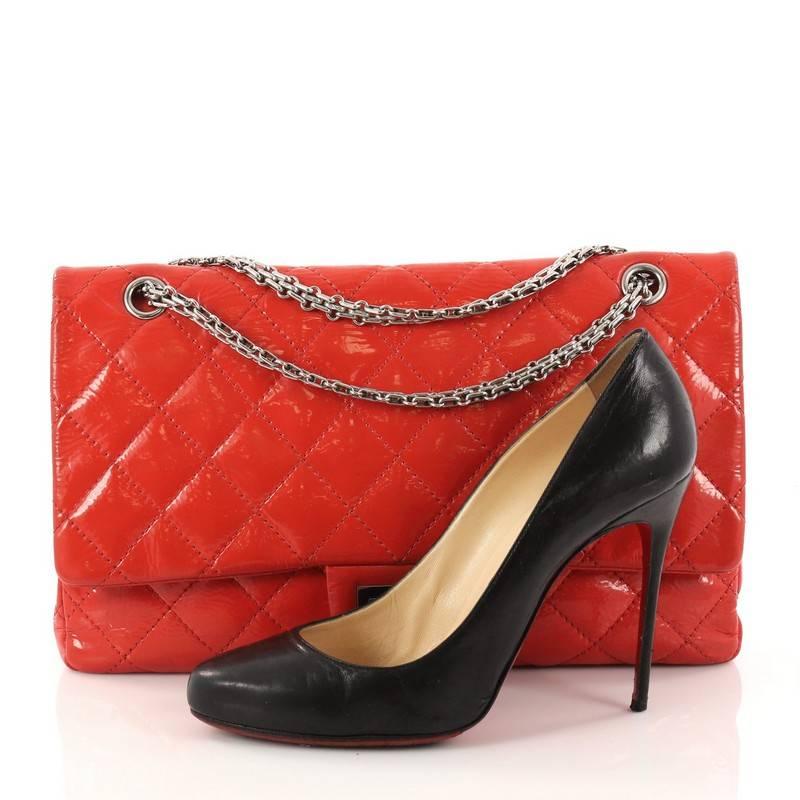 This authentic Chanel Reissue 2.55 Handbag Quilted Patent 227 is an elegant and timeless piece to add to any collection. Crafted from red patent leather, this stand-out flap features iconic Chanel reissue chain link strap, signature diamond