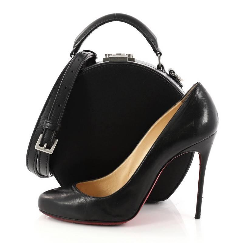This authentic Saint Laurent Mica Hatbox Handbag Leather Small is a chic and stylish bag perfect for the modern fashionista. Crafted in black leather, this structured bag features a flat leather handle, detachable adjustable strap, round silhouette,