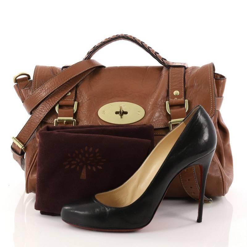 This authentic Mulberry Alexa Satchel Polished Buffalo Medium depicts a stylish and functional style made for fashionistas. Crafted from brown polished buffalo leather, this oversized satchel features a braided top handle, fold over flap with