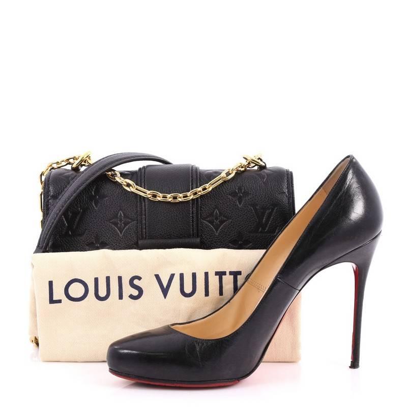 This authentic Louis Vuitton Saint Sulpice Handbag Monogram Empreinte Leather BB from 2017 is a bag that displays a elegant and chic design for day-to-evening looks. Crafted in black monogram empreinte leather, this bag features gold sliding chain