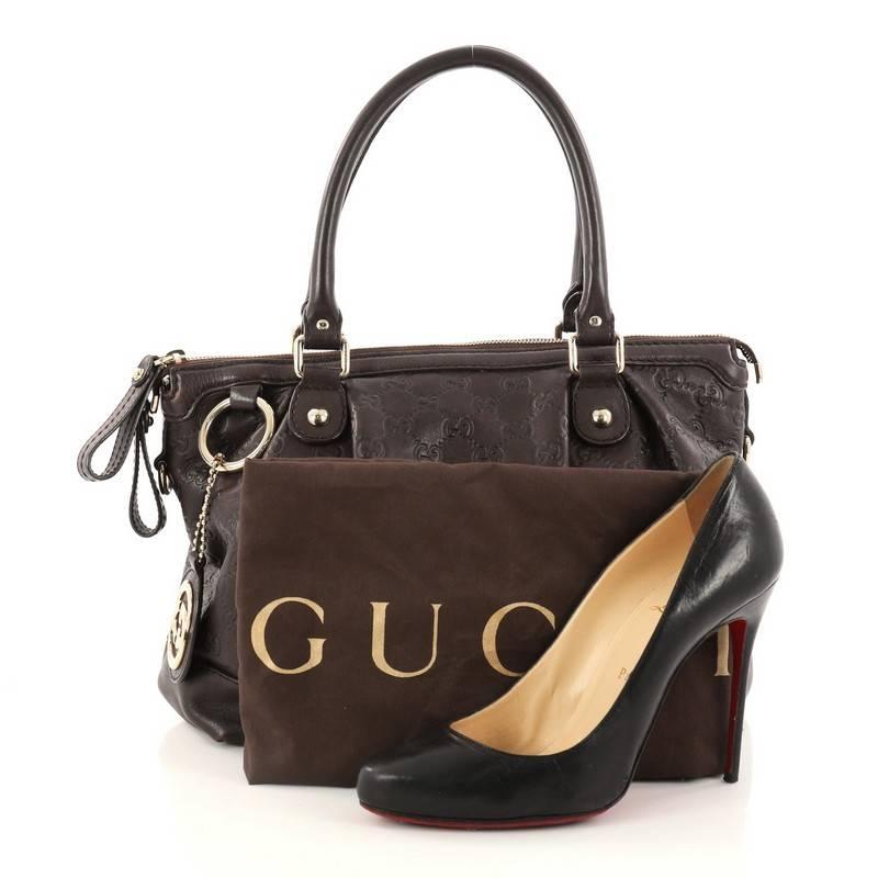 This authentic Gucci Sukey Top Handle Satchel Guccissima Leather Medium is a chic tote ideal for everyday wear. Crafted from Gucci's dark brown guccissima leather, this roomy tote features a ruched design, dual-rolled handles, and gold-tone hardware