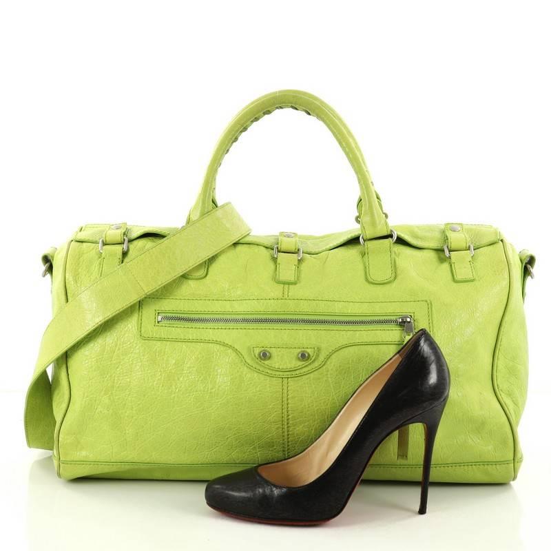 This authentic Balenciaga Squash S Boston Duffle Bag Lambskin Small is a tote that will hold all of your necessities and is suitable as a casual work bag or light travel for both men and women. Crafted in neon green lambskin leather, this bag