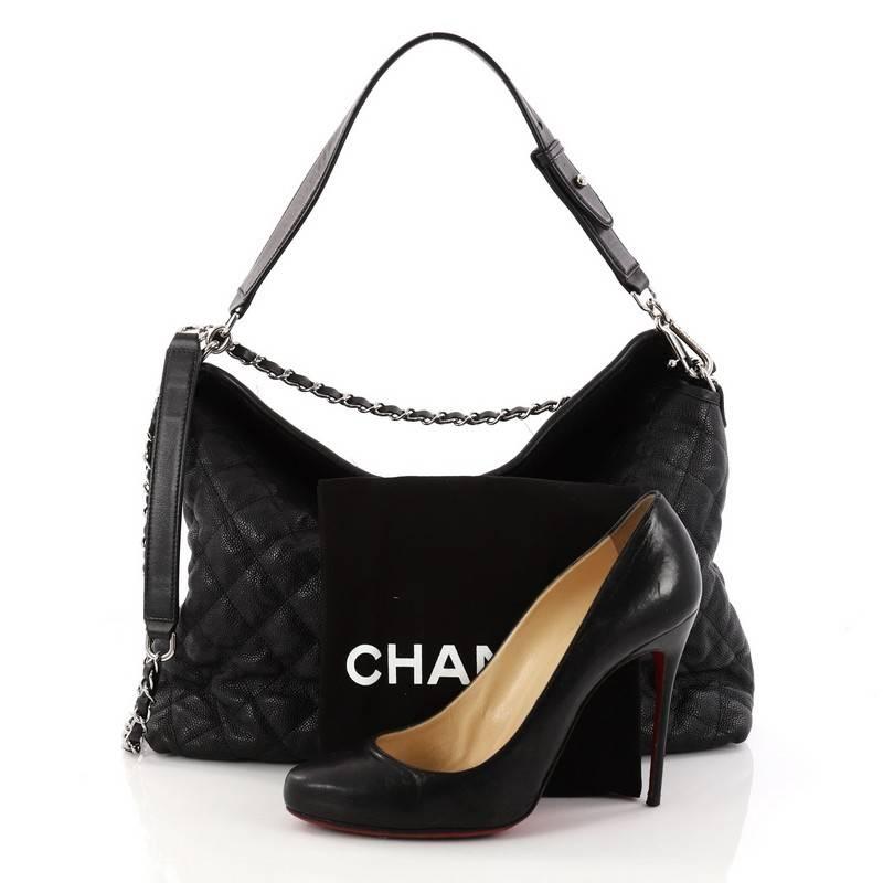 This authentic Chanel French Riviera Hobo Quilted Caviar Large showcases a subtly modern yet classic design made for the modern woman. Crafted in black quilted caviar leather, this luxurious bag features woven-in leather chain strap with leather