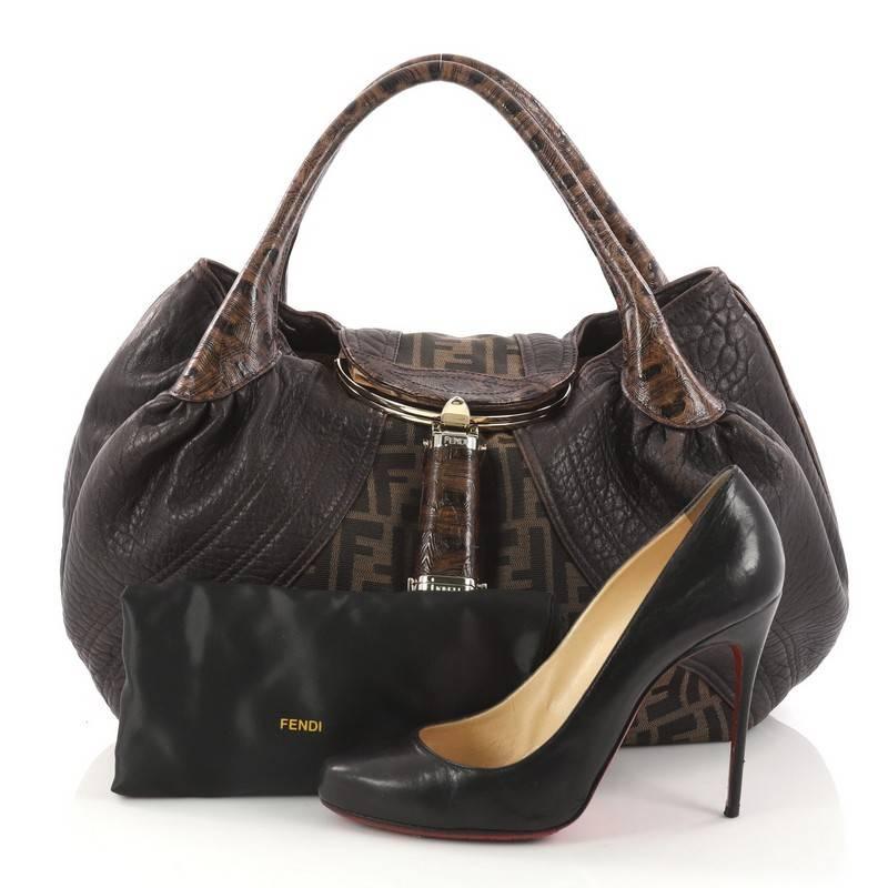 This authentic Fendi Tortoise Spy Bag Zucca Canvas and Leather showcase one of the brand's most popular design. Crafted from Fendi brown Zucca printed canvas and brown leather, this bag features dual-rolled genuine tortoise skin handles, a pleated