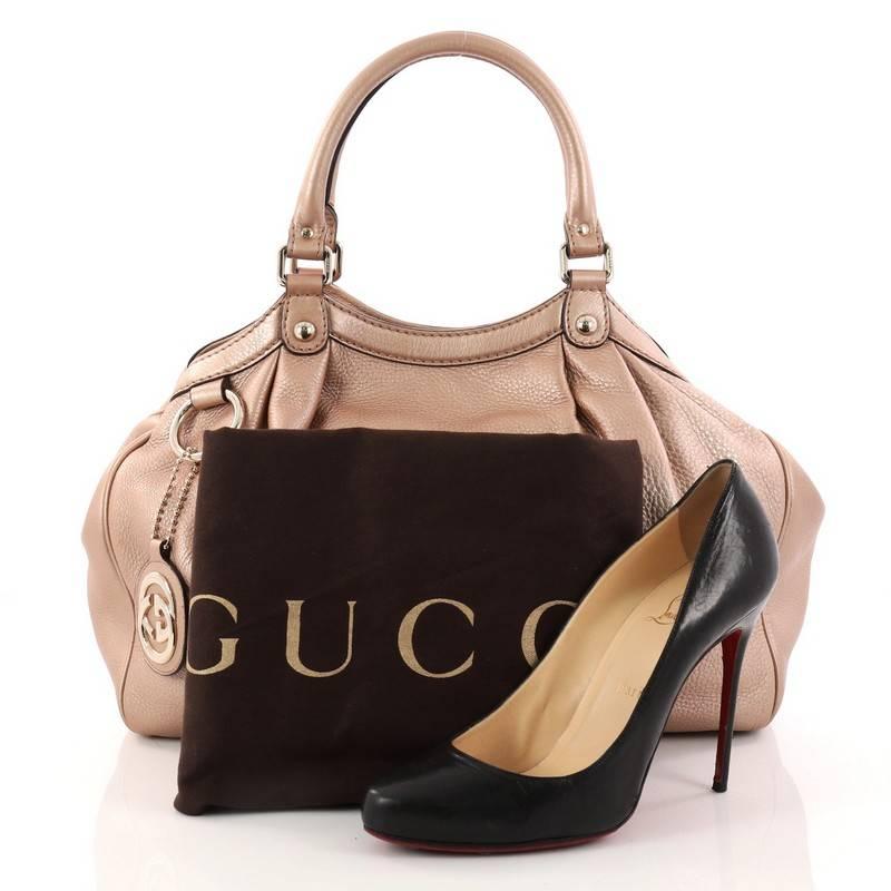 This authentic Gucci Sukey Tote Leather Medium is a chic tote ideal for your everyday wear. Crafted from metallic dusty rose leather, this pleated tote features dual-rolled leather top handles, side snap buttons, and gold-tone hardware accents. Its