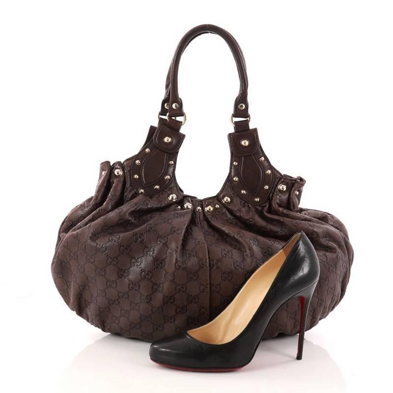 This authentic Gucci Pelham Shoulder Bag Studded Guccissima Leather Medium is perfect for everyday use. Crafted in brown pleated guccissima leather, this chic bag features dual-rolled leather handles, gold studded detailing at its top crest, and