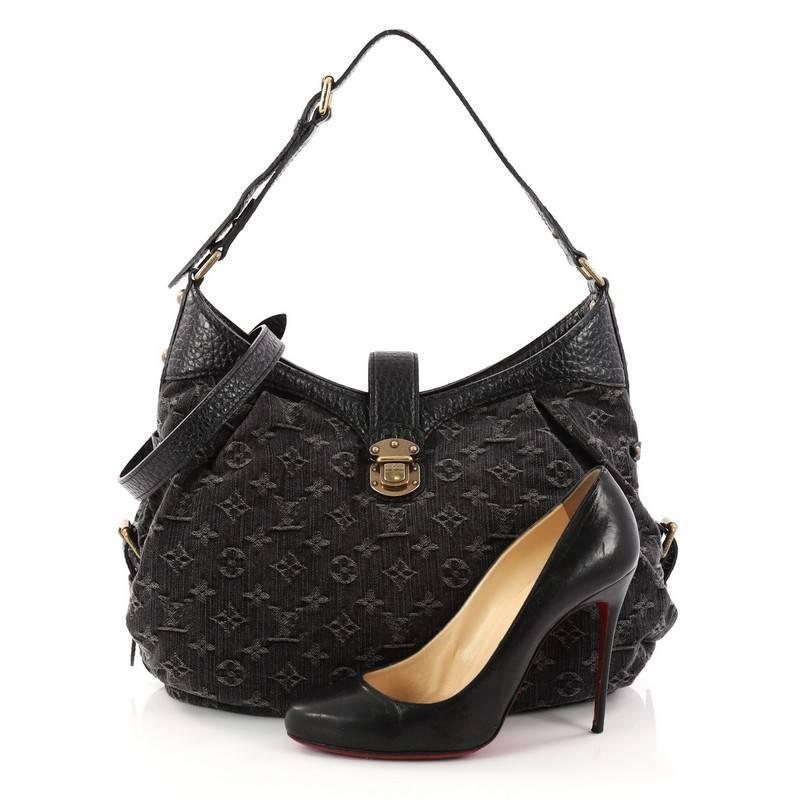 This authentic Louis Vuitton XS Hobo Denim is a contemporary take on a classic style. Crafted from black monogram denim, this hobo features an engraved push-lock hardware, adjustable leather strap, and aged gold-tone hardware accents. Its leather