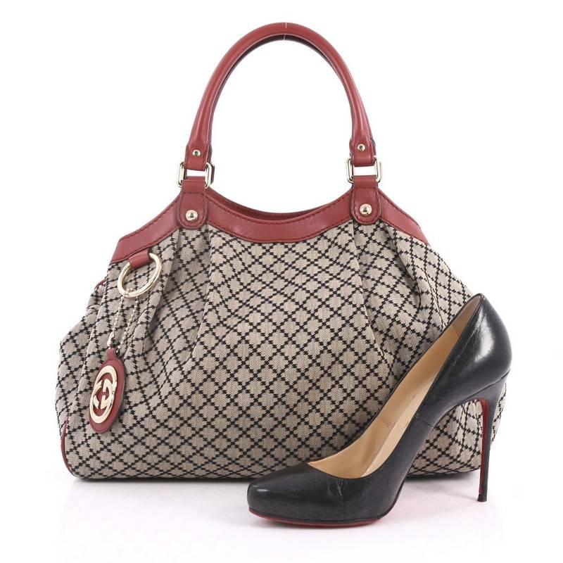 This authentic Gucci Sukey Tote Diamante Canvas Medium is sophisticated in design is modernly chic perfect for casual excursions. Crafted in signature beige diamante canvas with leather trims, this soft structured bag features dual-rolled handles,