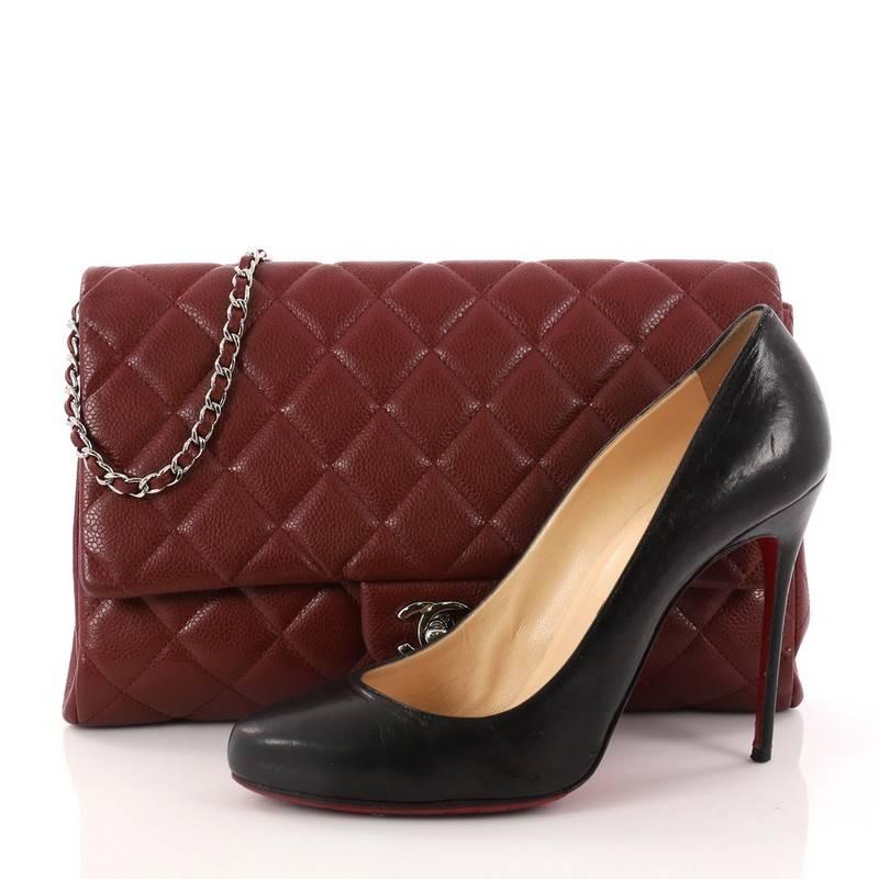 This authentic Chanel Clutch with Chain Quilted Caviar is an elegant accessory that adds a touch of glamour to any look. Crafted from dark red quilted caviar leather, this clutch features Chanel's signature diamond quilting, exterior back slip