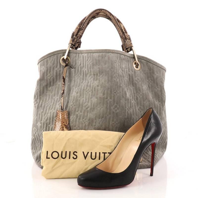This authentic Louis Vuitton Limited Edition Whisper Bag Monogram Suede and Python GM is one of Marc Jacob's design standouts from Louis Vuitton's 2008 Collection. Crafted from green embossed monogram suede, this practical bag features dual-rolled