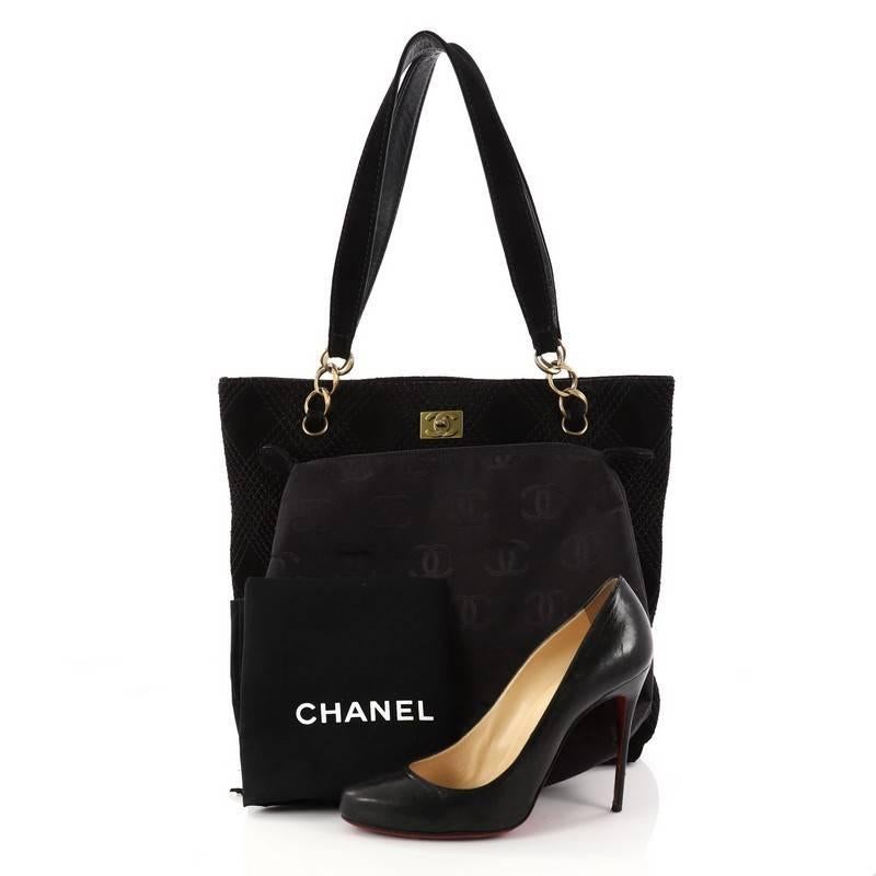 This authentic Chanel Vintage Stitch Tote Suede Medium showcases a modern and stylized design with vintage-inspired flair. Crafted in black suede, this tote features multiple quilt stitches in signature diamond design, dual strap with chain links,