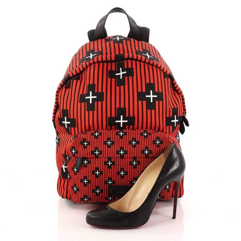 This authentic Givenchy Pocket Backpack Printed Nylon is the perfect mix of fashion and comfort. Constructed in red printed nylon, this eye-catching backpack features adjustable shoulder straps, exterior front zip pocket, two-way zip closure with
