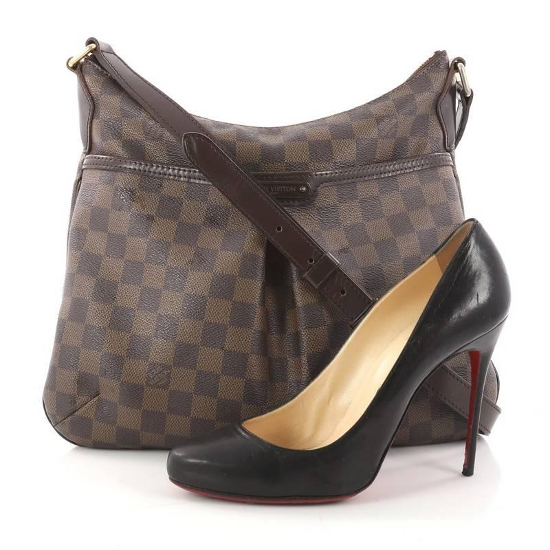 This authentic Louis Vuitton Bloomsbury Handbag Damier PM is a feminine yet versatile everyday bag made for the modern woman. Constructed from damier ebene coated canvas, this luxurious bag features an adjustable shoulder strap, dark brown leather
