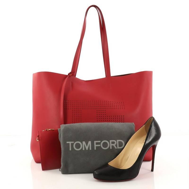 This authentic Tom Ford Logo Tote Perforated Leather Large is simple and classic in design ideal for everyday use. Crafted in red perforated leather, this tote features dual-flat leather handles and gold-tone hardware accents. Its wide top opening