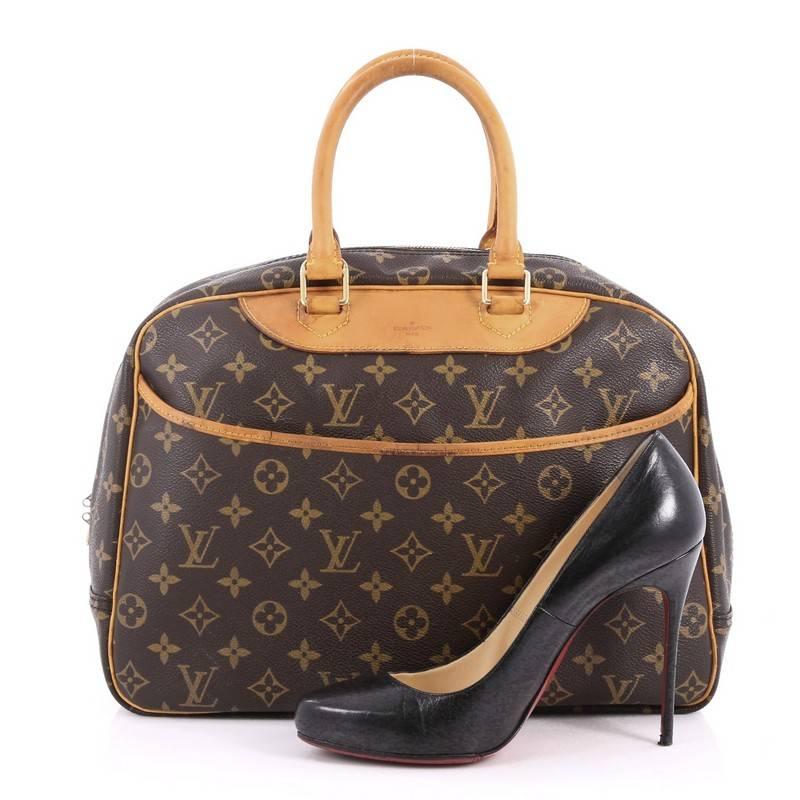 This authentic Louis Vuitton Deauville Handbag Monogram Canvas was popularly known as a vanity case yet has become an everyday staple. Constructed from brown monogram coated canvas, this bag features dual rolled vachetta leather handles and trims,