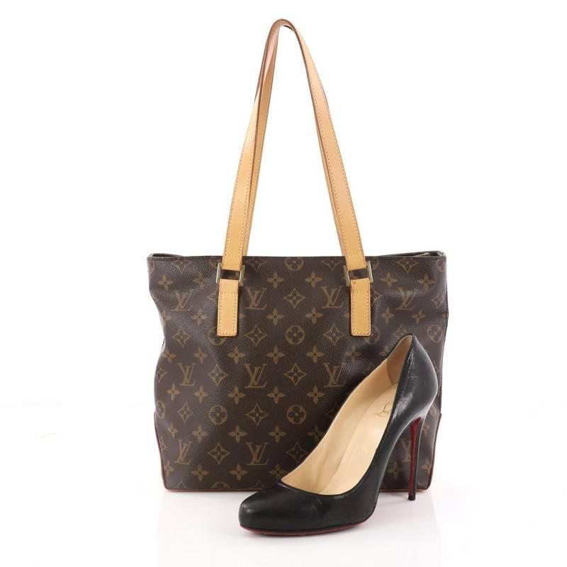 This authentic Louis Vuitton Cabas Piano Monogram Canvas is a practical and minimalist tote classic to the brand's design. Crafted with Louis Vuitton's iconic brown monogram coated canvas, this simple tote features tall cowhide leather handles and