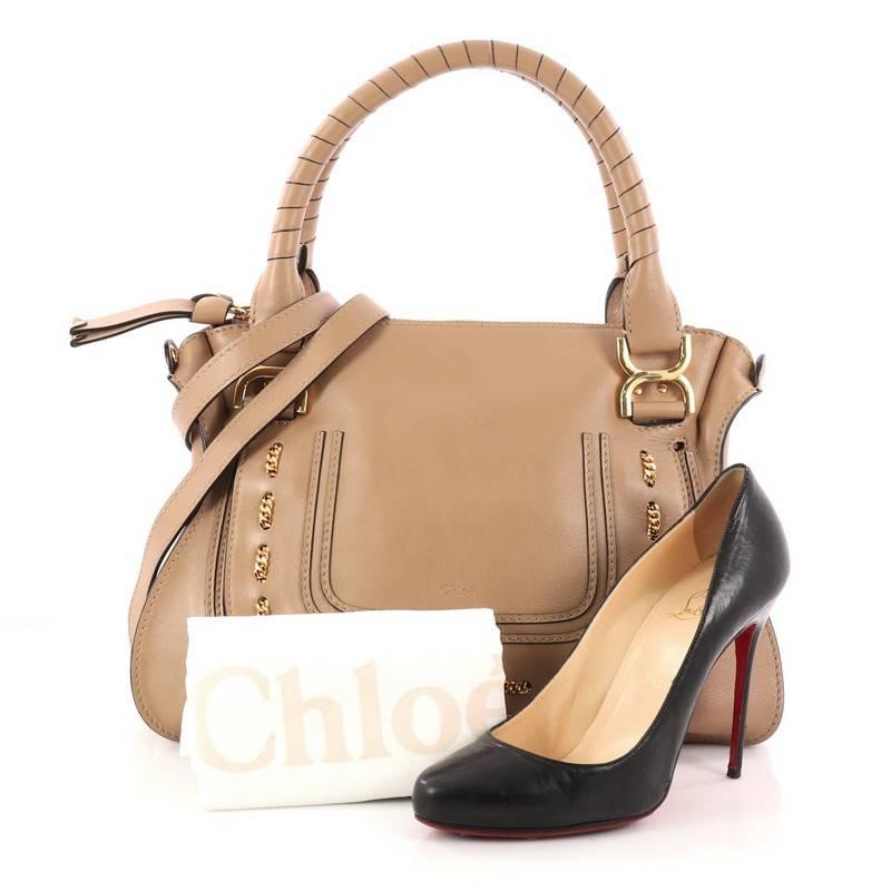 This authentic Chloe Marcie Satchel Leather with Chain Detail Medium is perfect for the on-the-go fashionista. Constructed from brown leather, this popular satchel features wrapped leather handles, horseshoe stitched front flap with unique woven in