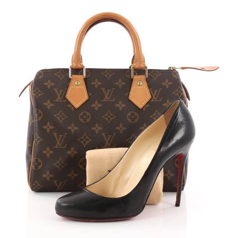 This authentic Louis Vuitton Speedy Handbag Monogram Canvas 25 is a classic must-have, making it ideal for everyday use. Constructed from Louis Vuitton's classic brown monogram coated canvas, this iconic Speedy features dual-rolled vachetta leather