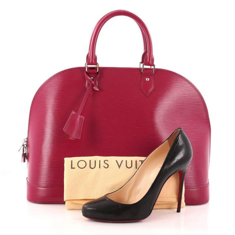 This authentic Louis Vuitton Alma Handbag Epi Leather GM is a chic and sophisticated bag perfect for your everyday use. Constructed with magenta epi leather, this dome-like bag features a sturdy base, protective base studs, dual-rolled handles,