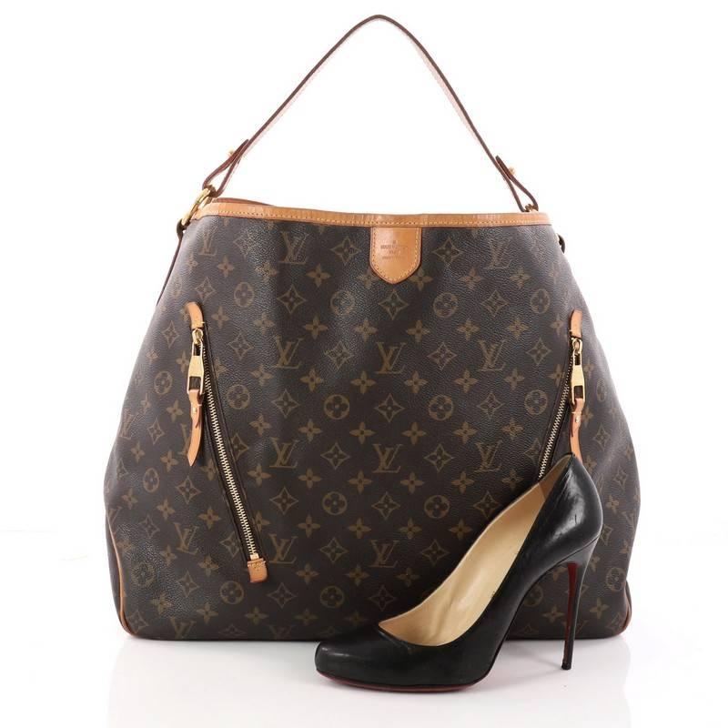 This authentic Louis Vuitton Delightful Handbag Monogram Canvas GM is a versatile hobo that can be used everyday. Constructed from the brand's classic brown monogram coated canvas with cowhide leather trims, this bag features a flat leather loop